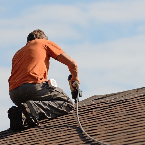 A Roofer Repairs Shingles.