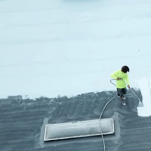 Contractor Sprays on Roof Restoration Coating