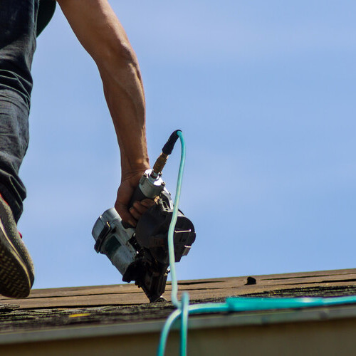 A Roofer Installs Shingles