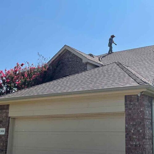A Roofer Inspects a Roof.